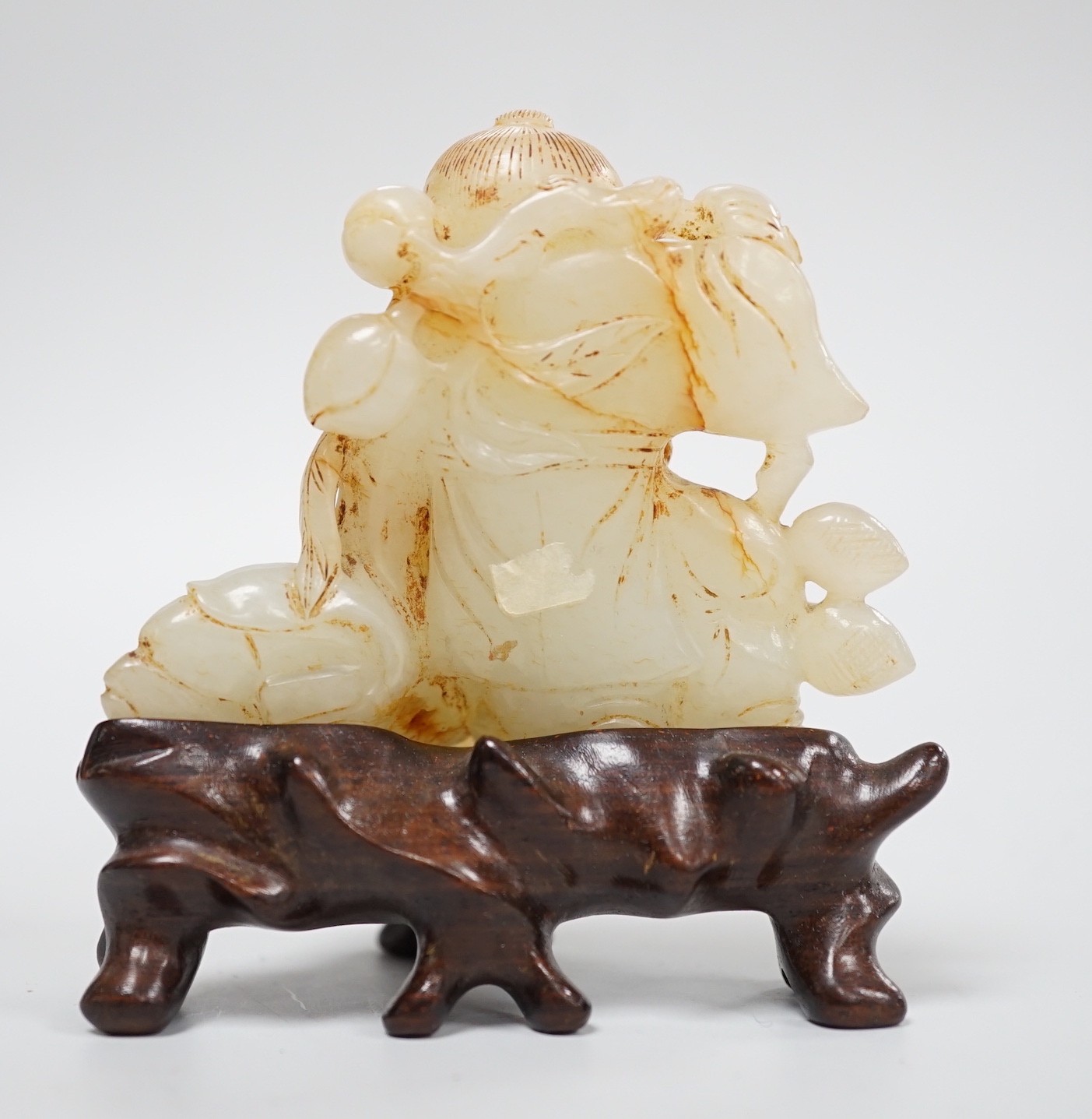 A Chinese white and russet jade group of three boys, 18th/19th century, 7.2 cm, wood stand